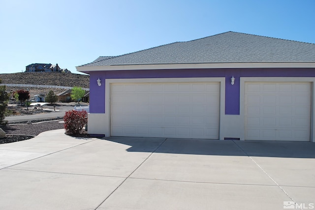 garage with concrete driveway