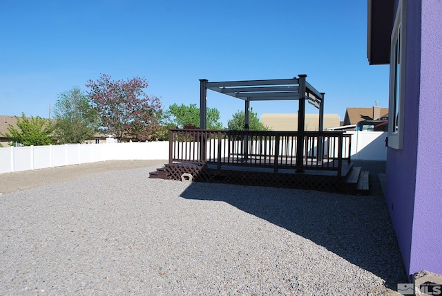 exterior space featuring a deck and fence