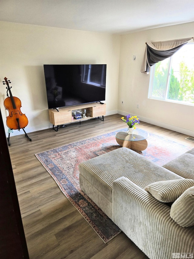 living room featuring wood finished floors and baseboards