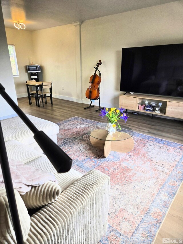 living room featuring wood finished floors and baseboards