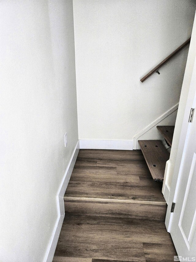 stairs with wood finished floors and baseboards