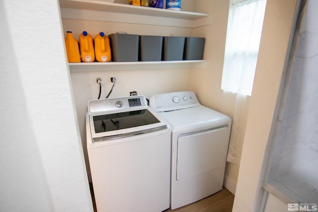 washroom featuring separate washer and dryer and wood finished floors