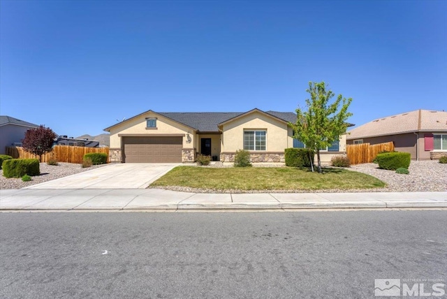 ranch-style home with an attached garage, fence, stone siding, and stucco siding