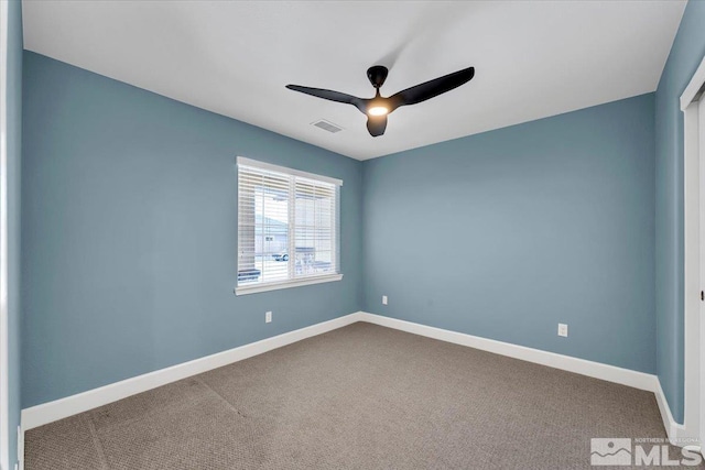unfurnished room with carpet floors, a ceiling fan, baseboards, and visible vents