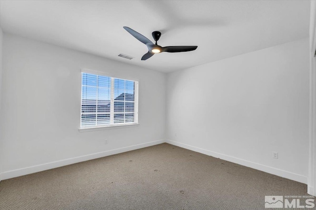 carpeted empty room with a ceiling fan, baseboards, and visible vents