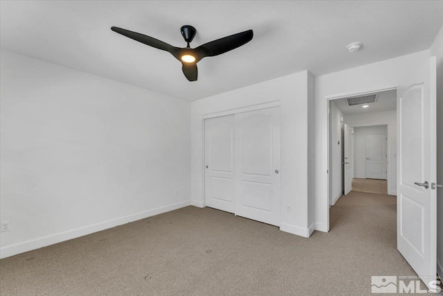 unfurnished bedroom featuring light colored carpet, baseboards, and visible vents