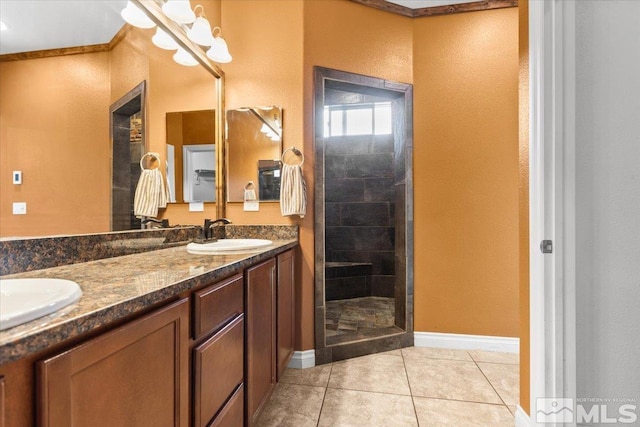 bathroom featuring a sink, baseboards, tile patterned flooring, and double vanity