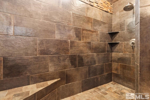 interior details featuring tiled shower