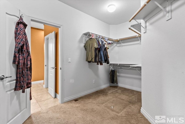 spacious closet with carpet floors and visible vents