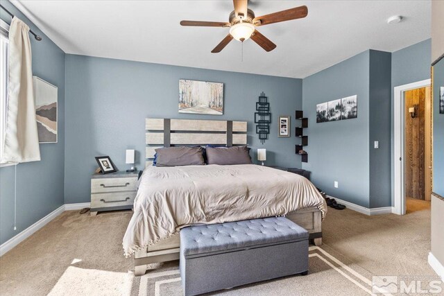 carpeted bedroom with baseboards and ceiling fan