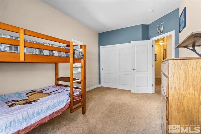 carpeted bedroom featuring baseboards