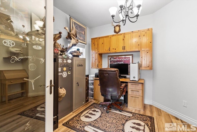 office featuring baseboards, wood finished floors, and a chandelier