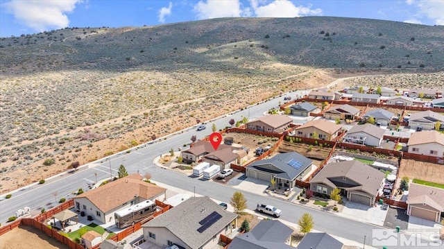 birds eye view of property featuring a mountain view and a residential view