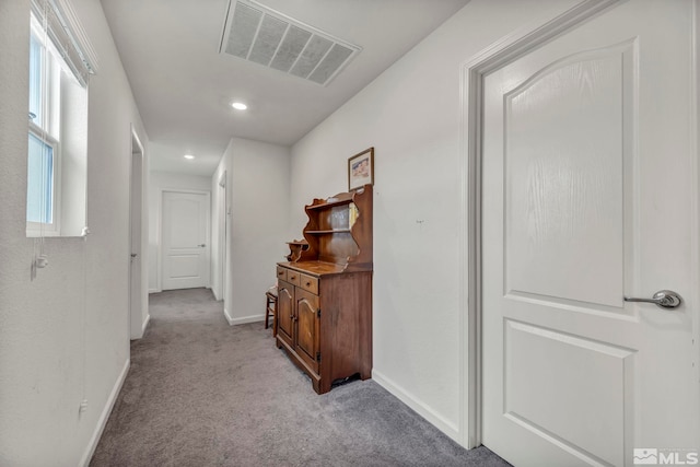 hall with light colored carpet, baseboards, visible vents, and recessed lighting
