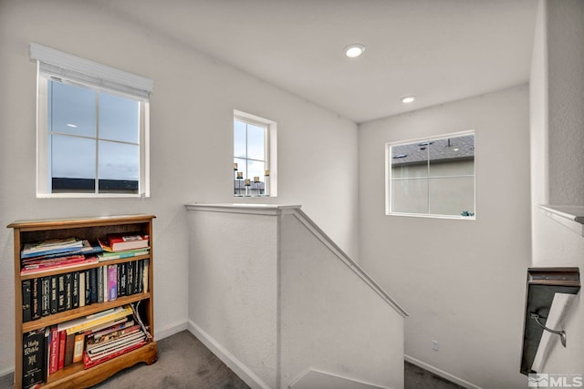 interior space with baseboards, carpet, and recessed lighting
