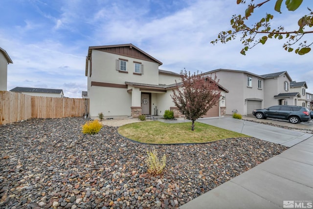 traditional-style home with fence, stucco siding, concrete driveway, and a garage