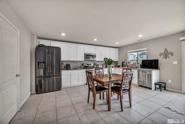 dining room with recessed lighting, baseboards, and light tile patterned floors