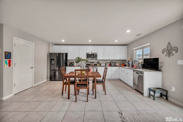 kitchen with light tile patterned floors, stainless steel appliances, recessed lighting, and white cabinetry