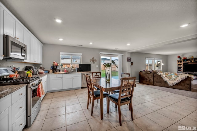 dining room with recessed lighting and light tile patterned floors