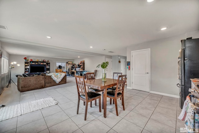 dining room with recessed lighting and light tile patterned floors