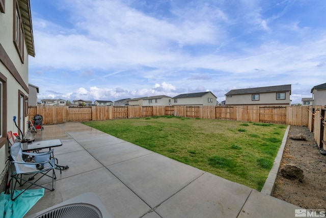 view of yard featuring a fenced backyard, a patio area, and a residential view