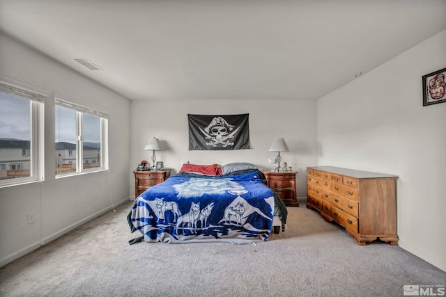 carpeted bedroom featuring baseboards and visible vents