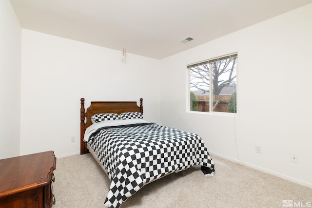 carpeted bedroom with visible vents and baseboards