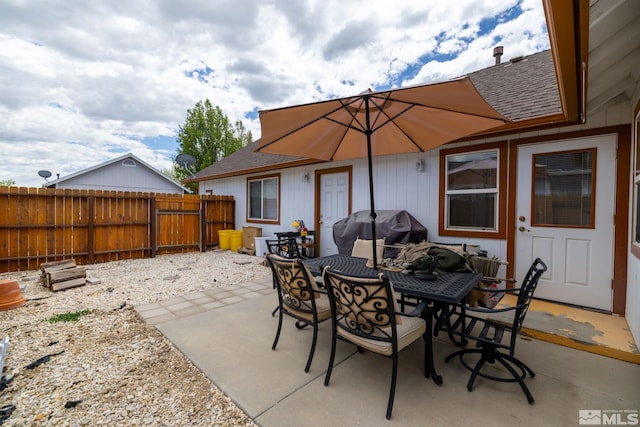 view of patio / terrace with area for grilling, fence, and outdoor dining space