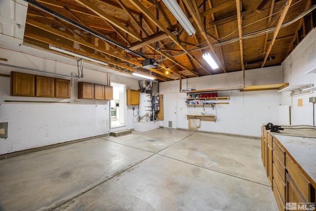 garage featuring a garage door opener and a workshop area