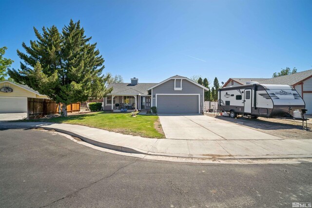 single story home with concrete driveway, an attached garage, and covered porch