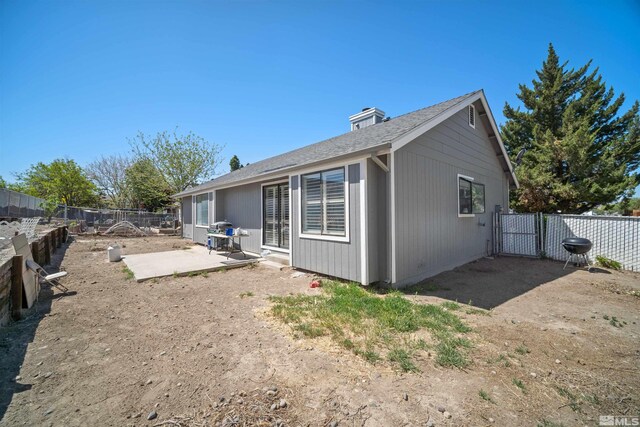 rear view of property with a patio area and a fenced backyard