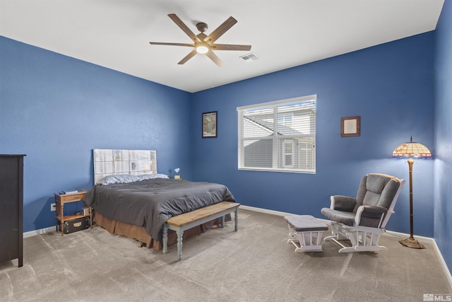 carpeted bedroom featuring baseboards and a ceiling fan