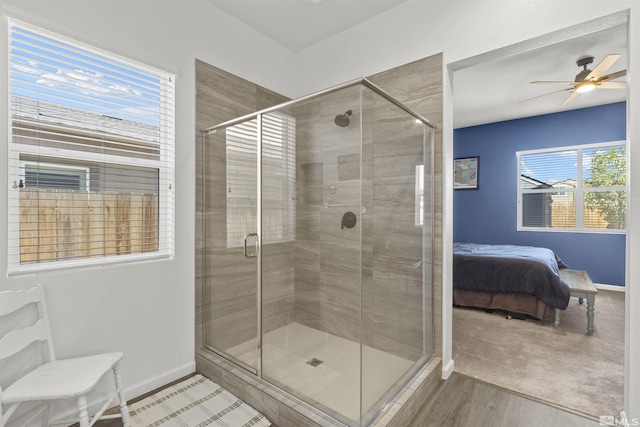 full bath featuring a shower stall, baseboards, a ceiling fan, and connected bathroom