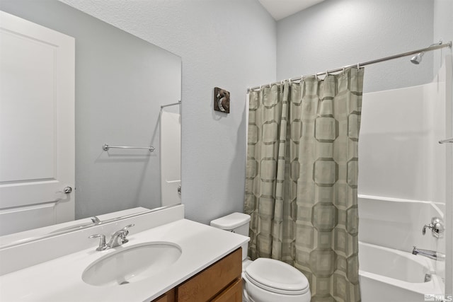 full bath with toilet, vanity, shower / bath combination with curtain, and a textured wall