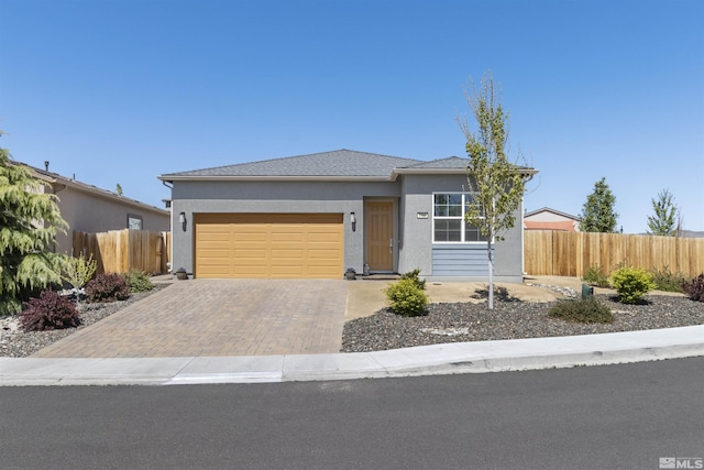 single story home with fence, an attached garage, driveway, and stucco siding