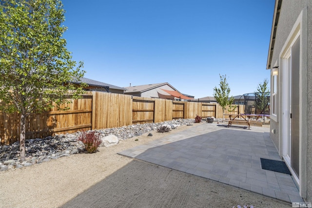 view of patio / terrace featuring a trampoline and a fenced backyard