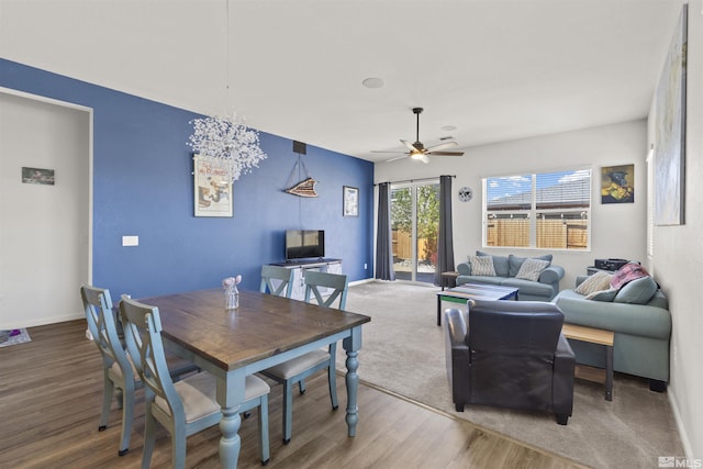 dining space with wood finished floors, ceiling fan, and baseboards