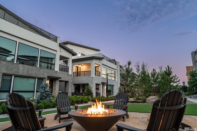 view of patio / terrace featuring a fire pit and a balcony