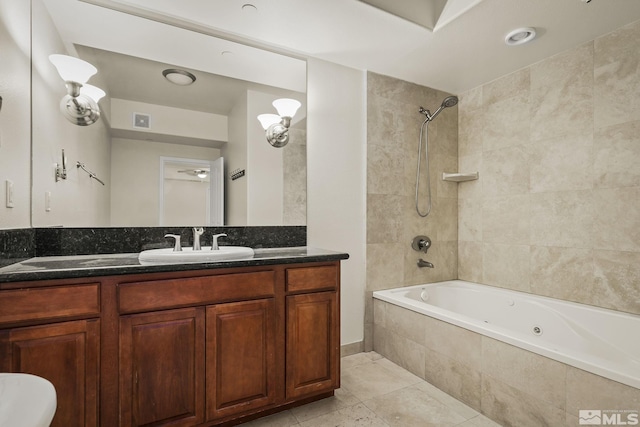 bathroom featuring tiled shower / bath combo, vanity, and tile patterned flooring