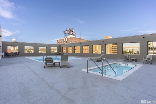 community pool featuring a patio and a community hot tub