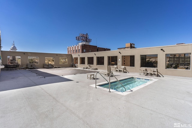 view of pool featuring a patio and a hot tub