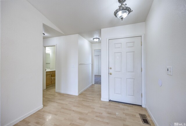 entrance foyer featuring light wood-style floors and baseboards