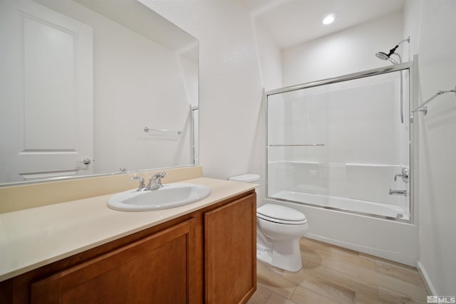 bathroom with toilet, vanity, and shower / washtub combination