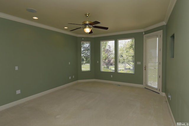 spare room featuring light carpet, ornamental molding, a ceiling fan, baseboards, and recessed lighting