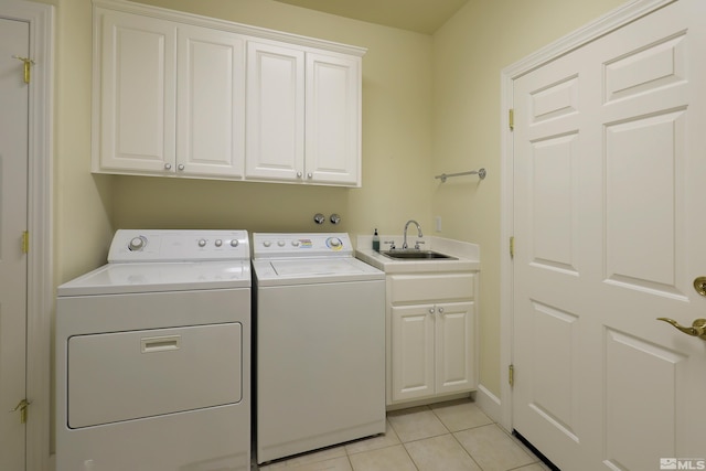 laundry room with cabinet space, separate washer and dryer, and light tile patterned floors