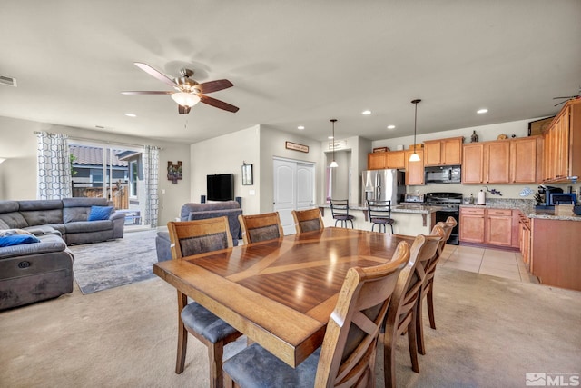 dining room with ceiling fan, light colored carpet, and recessed lighting