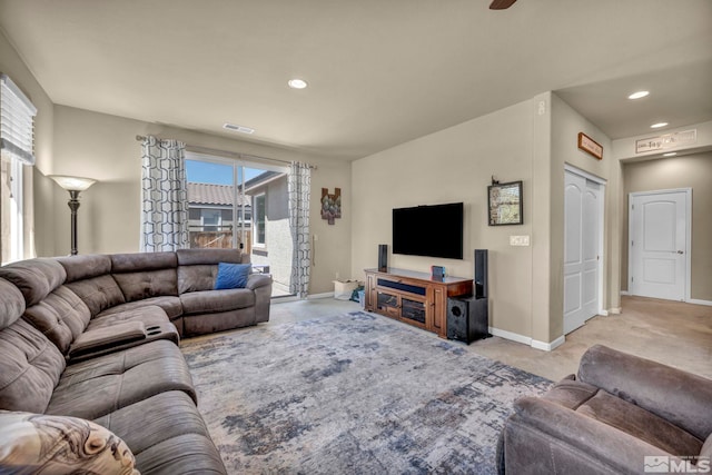 living room featuring light carpet, baseboards, and recessed lighting