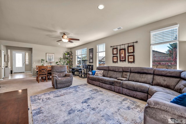 living area with plenty of natural light, a ceiling fan, light colored carpet, and recessed lighting
