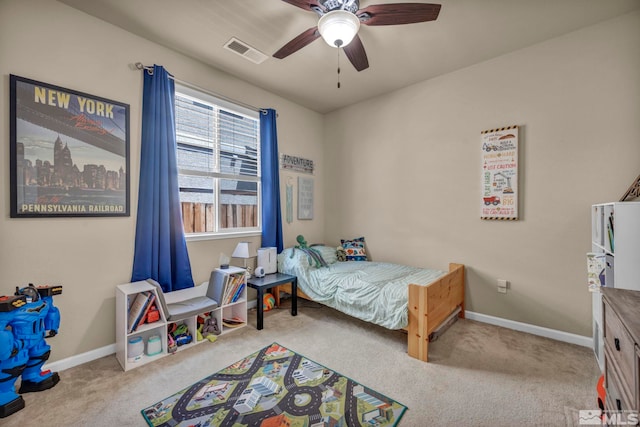 carpeted bedroom featuring baseboards and ceiling fan