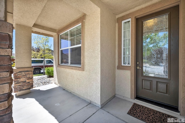 property entrance featuring stucco siding